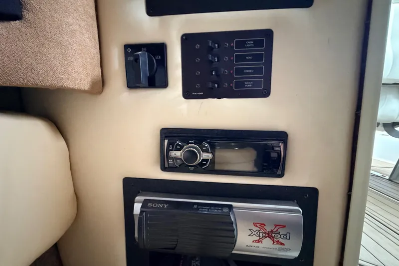  Yacht Photos Pics Control panel of a 2004 Cobalt 343 boat with audio system and switches.