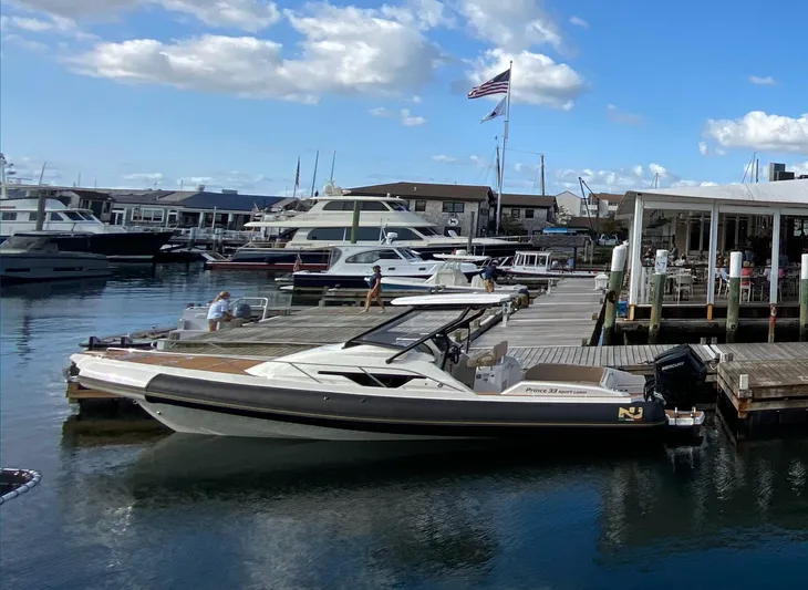  Yacht Photos Pics Nuova Jolly Prince 33 SPORT CABIN 2025 docked at a marina under a blue sky.