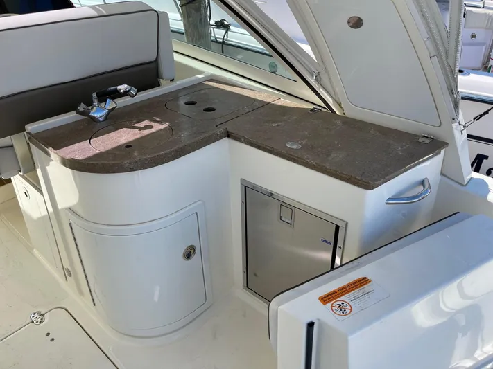  Yacht Photos Pics 2016 World Cat 320 DC boat interior with kitchenette and storage compartments.