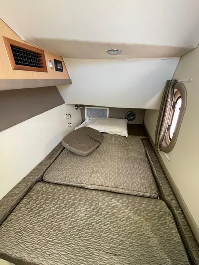  Yacht Photos Pics 2016 World Cat 320 DC cabin interior with bed and porthole window.