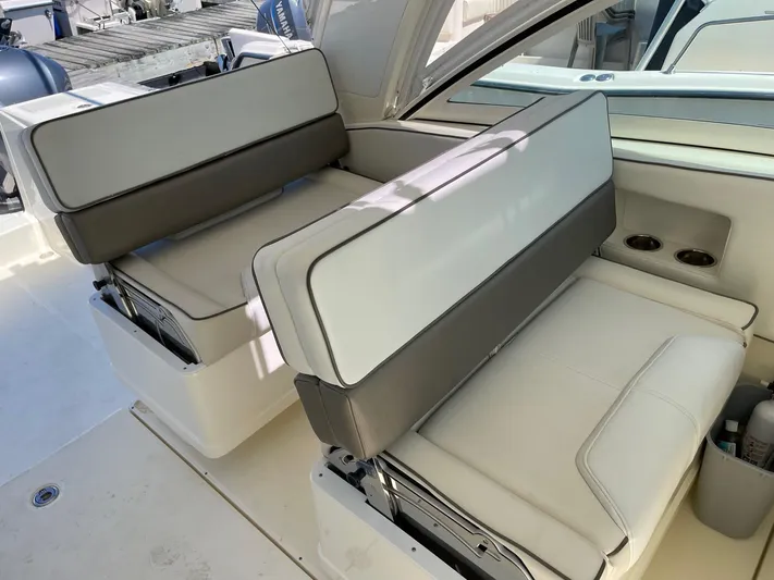  Yacht Photos Pics 2016 World Cat 320 DC boat interior with cushioned seating and cup holders.