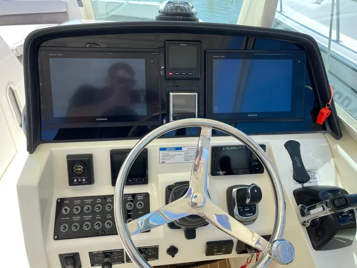  Yacht Photos Pics 2016 World Cat 320 DC helm with dual Garmin displays and steering wheel.