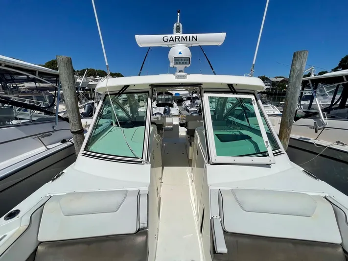  Yacht Photos Pics 2016 World Cat 320 DC boat docked, featuring Garmin navigation system.
