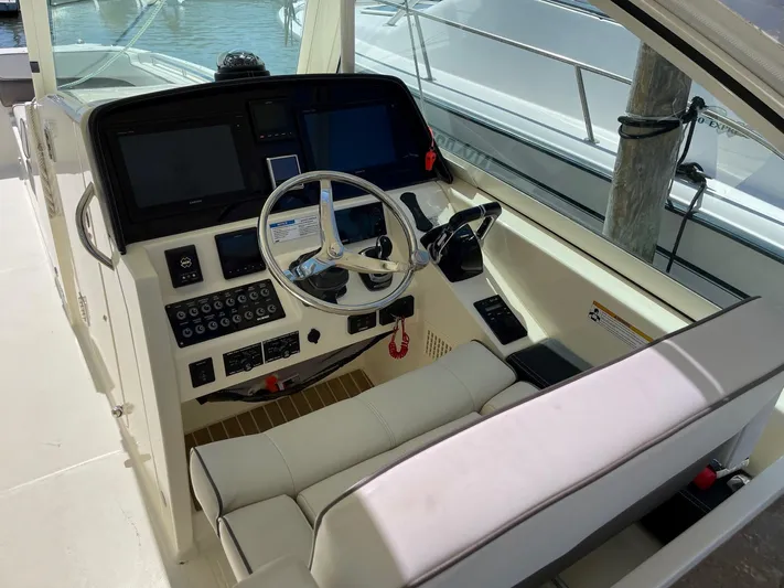  Yacht Photos Pics 2016 World Cat 320 DC helm station with modern controls and navigation equipment.