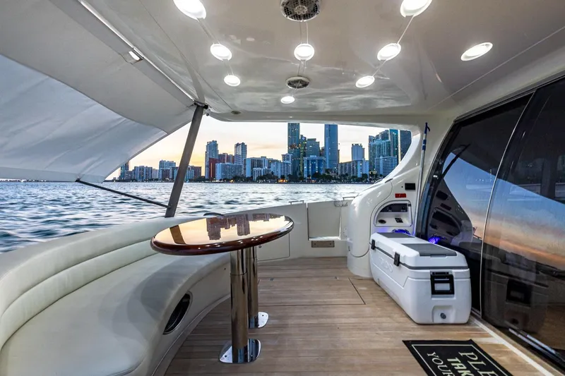 "pony Up" Yacht Photos Pics Luxurious 2003 Azimut Fly 68 yacht interior with city skyline view at sunset.