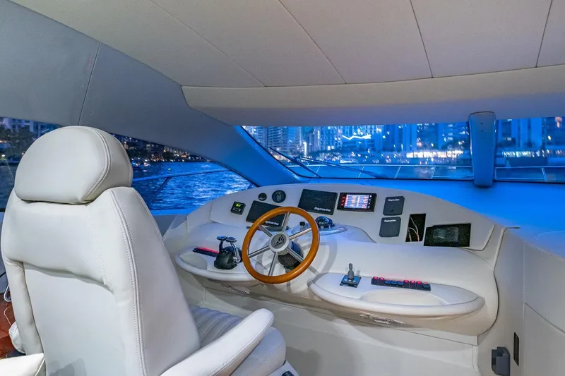"pony Up" Yacht Photos Pics Cockpit of 2003 Azimut Fly 68 yacht with modern controls and city skyline view.