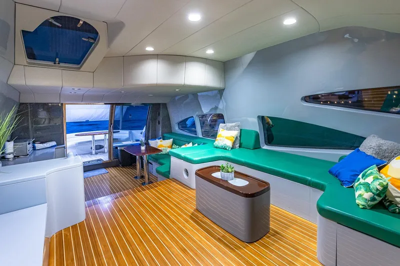 "pony Up" Yacht Photos Pics Luxurious interior of 2003 Azimut Fly 68 yacht with modern seating and wooden flooring.