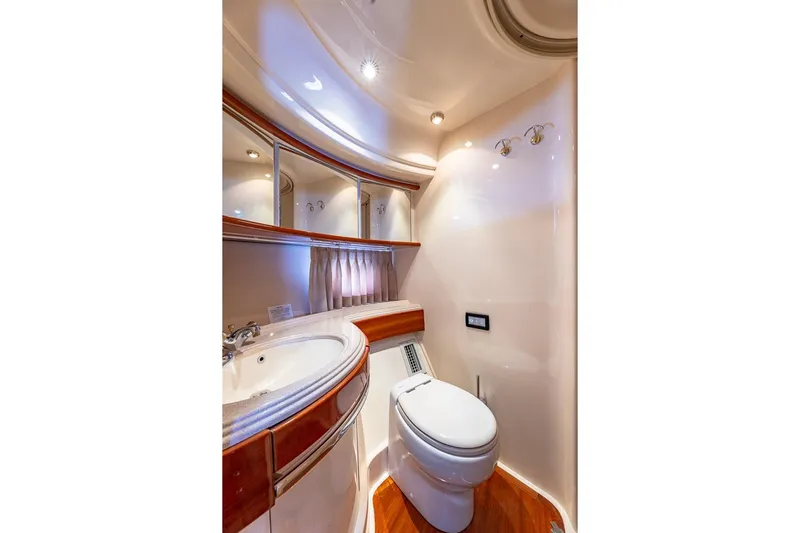 "pony Up" Yacht Photos Pics Luxurious bathroom in 2003 Azimut Fly 68 yacht with elegant fixtures and wood accents.