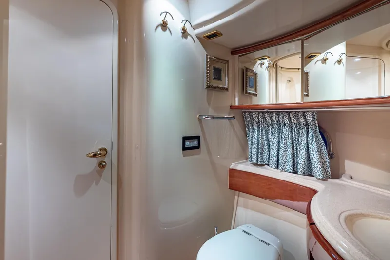 "pony Up" Yacht Photos Pics Luxurious bathroom interior of 2003 Azimut Fly 68 yacht with elegant fixtures and decor.