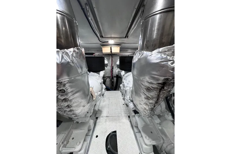 "pony Up" Yacht Photos Pics Engine room of 2003 Azimut Fly 68 yacht, featuring insulated components and metallic surfaces.