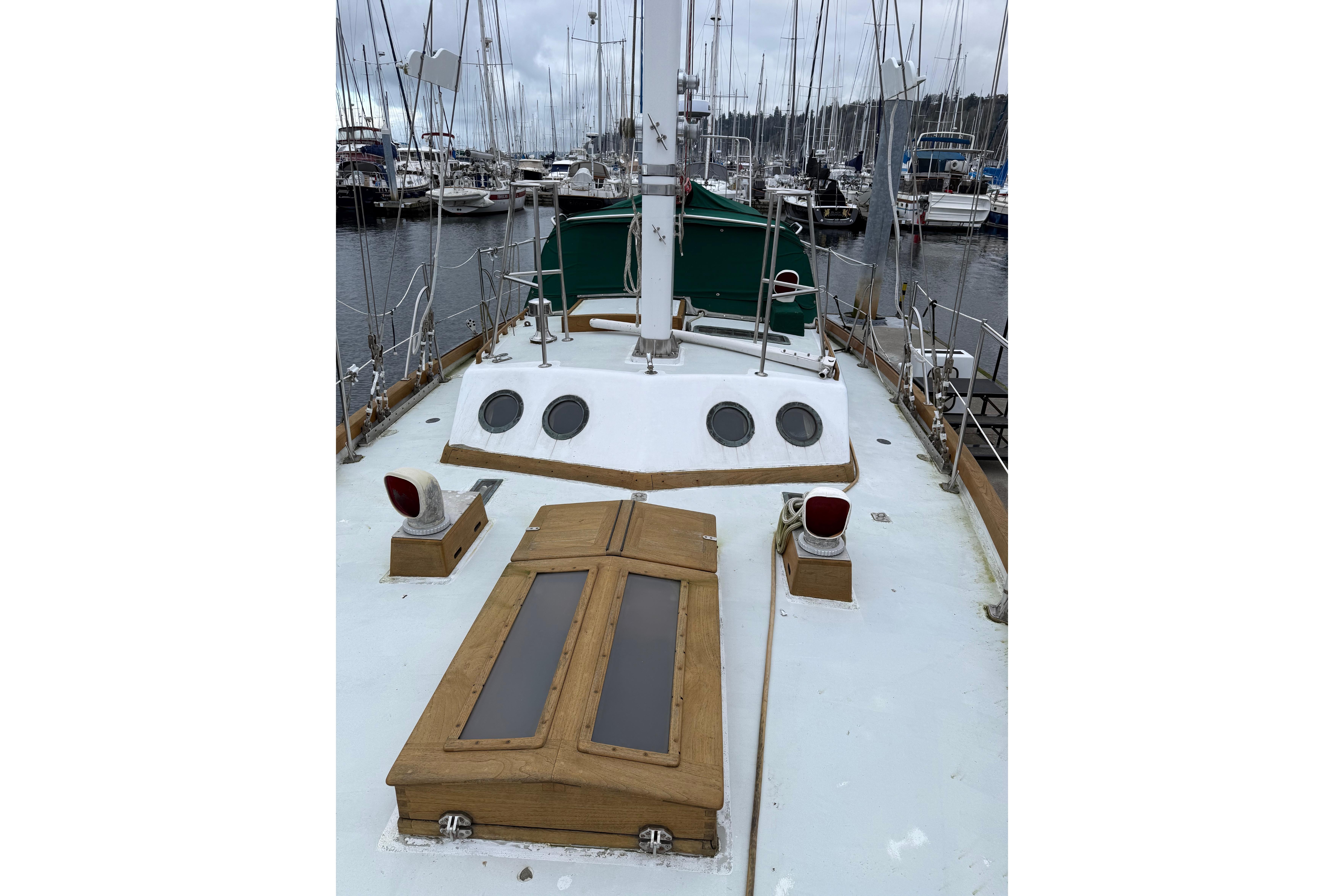 Sailboat deck view in marina, HMMD 46 model, 1990, with wooden accents and portholes.