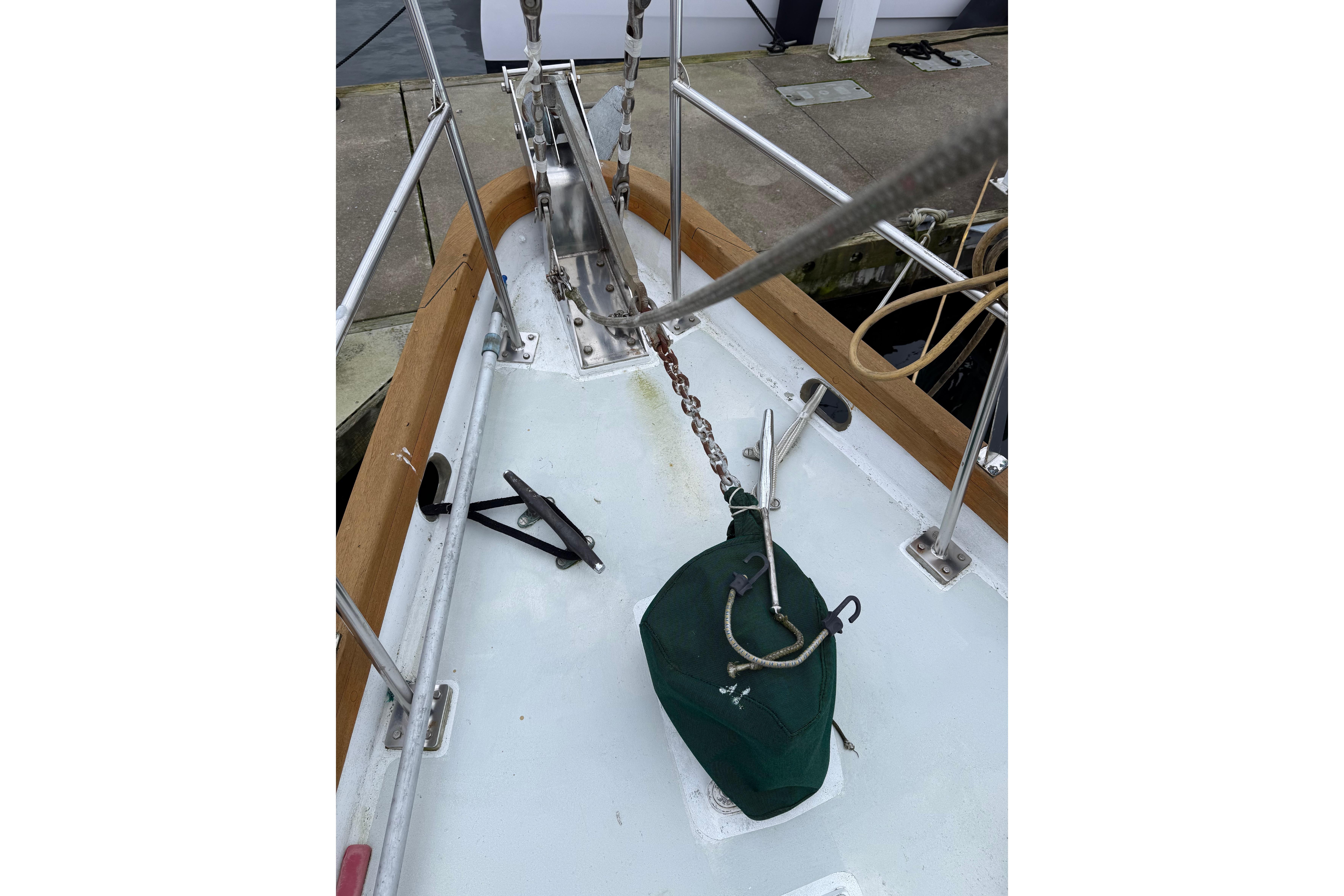 Bow of 1990 HMMD 46 sailboat with anchor chain and green cover.