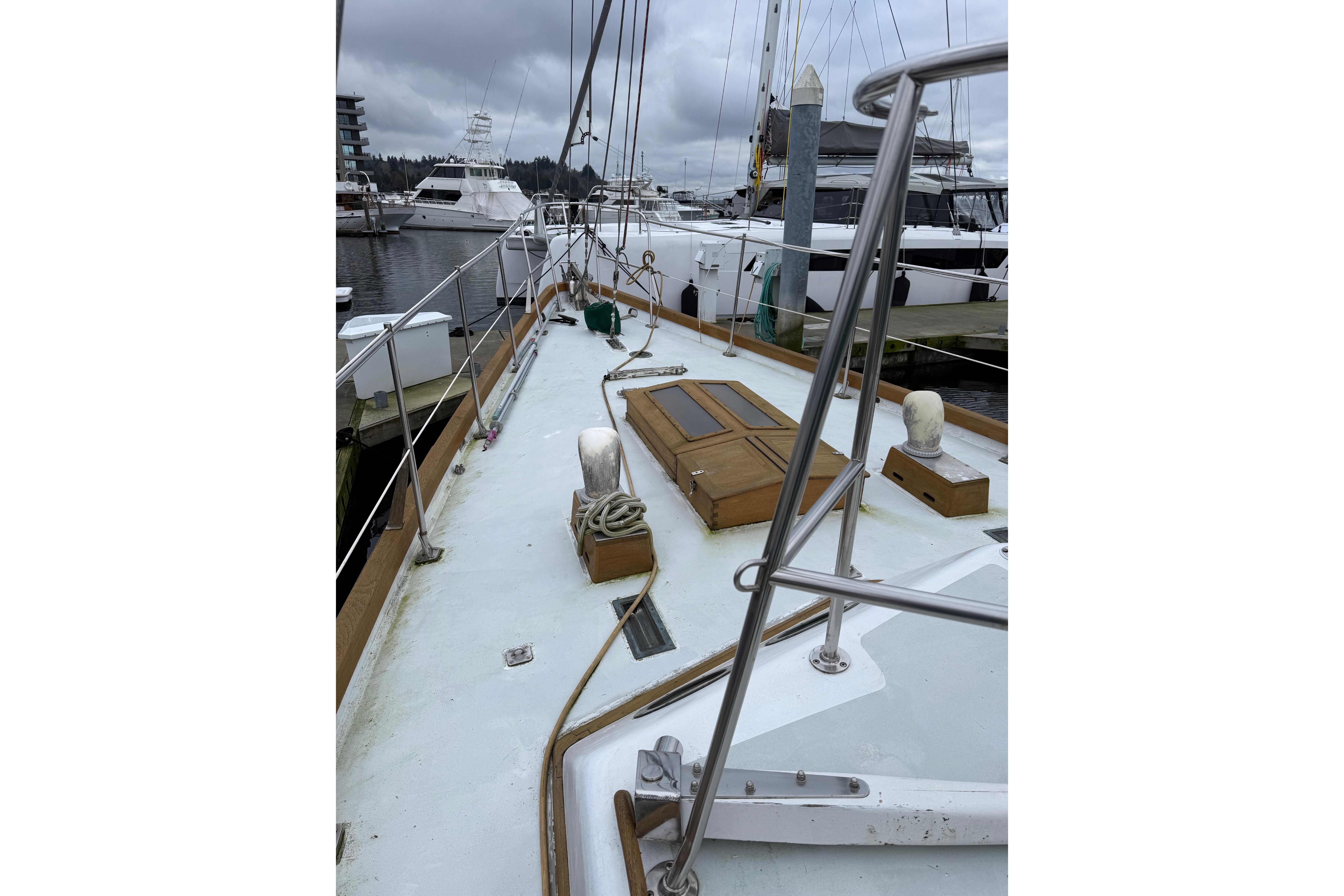 Sailboat deck view at marina, HMMD 46 model, 1990, overcast sky.