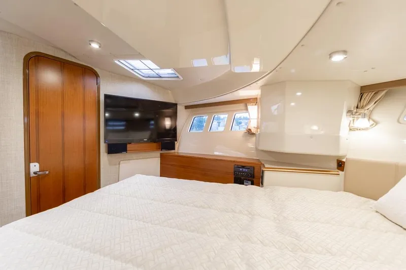  Yacht Photos Pics 2025 Ranger Tugs 43 Command Bridge cabin with bed, TV, and windows.