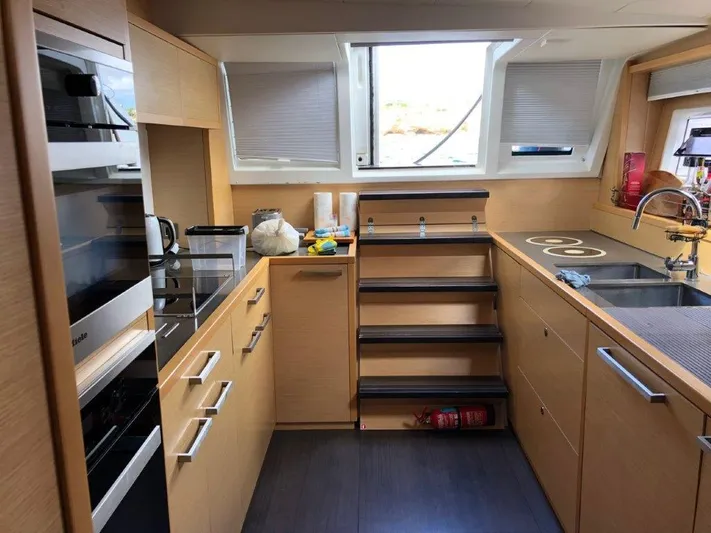  Yacht Photos Pics Modern kitchen interior on a 2015 Lagoon 620 yacht, featuring sleek cabinetry and appliances.