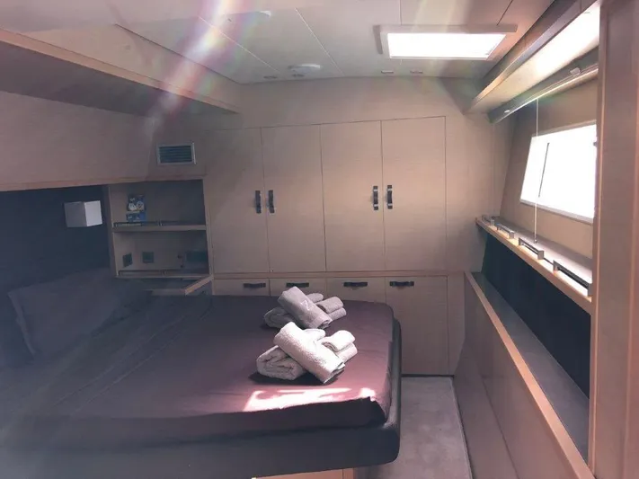  Yacht Photos Pics Luxurious cabin interior of 2015 Lagoon 620 yacht with neatly arranged towels.