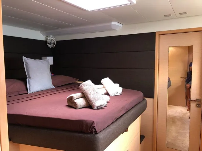  Yacht Photos Pics Luxurious bedroom interior of 2015 Lagoon 620 yacht with neatly arranged towels.