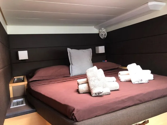  Yacht Photos Pics Luxurious cabin interior of 2015 Lagoon 620 yacht with neatly arranged towels on the bed.