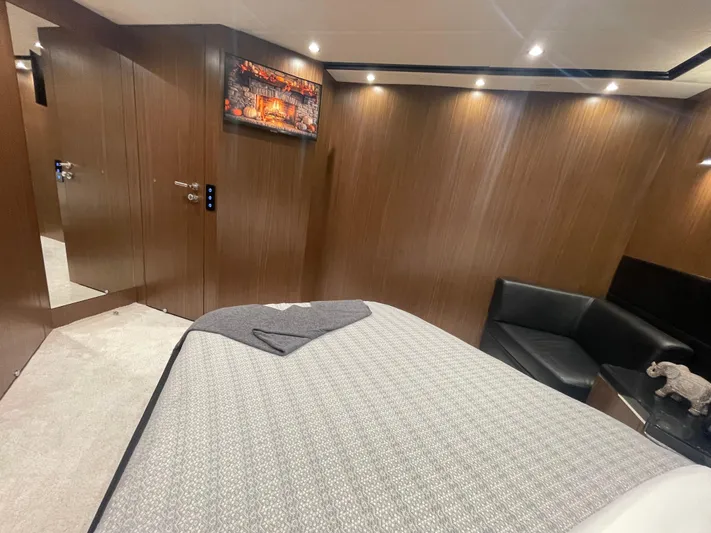 Blade Yacht Photos Pics Luxurious yacht bedroom interior with wood paneling, modern lighting, and a cozy bed.