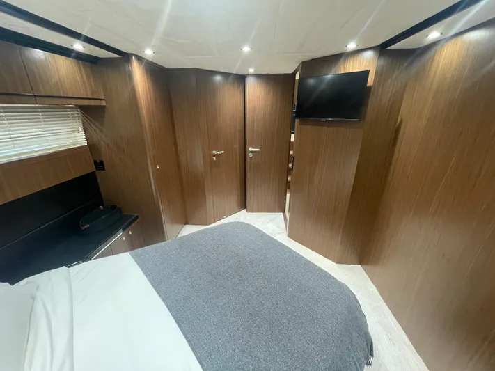 Blade Yacht Photos Pics Luxurious bedroom interior in 2007 Pantera 80 GT yacht with wood paneling and modern amenities.