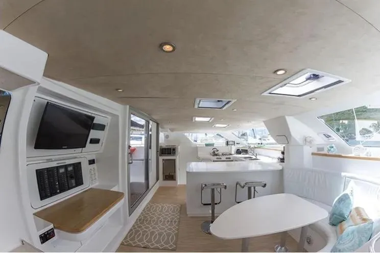 Electrify Yacht Photos Pics Interior of 2018 Voyage Yachts 480E, featuring modern kitchen and seating area.