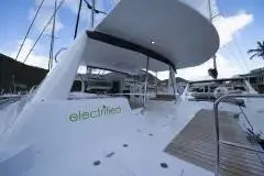 Electrify Yacht Photos Pics 2018 Voyage Yachts 480E catamaran docked, featuring "electrified" branding on the side.
