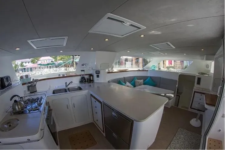 Electrify Yacht Photos Pics Interior of 2018 Voyage Yachts 480E, featuring modern kitchen and seating area.