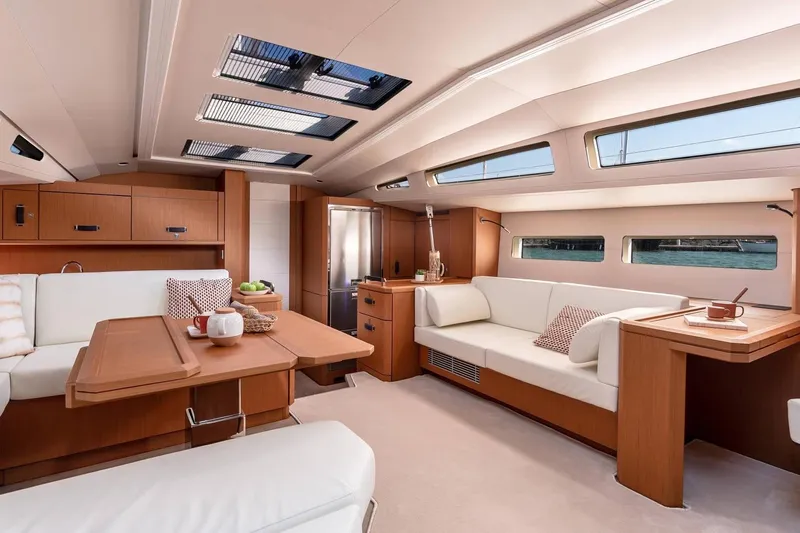  Yacht Photos Pics Luxurious interior of 2022 Jeanneau 60 yacht with elegant wood finishes and modern design.