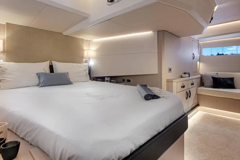  Yacht Photos Pics Luxurious interior of 2022 Jeanneau 60 yacht, featuring elegant bedroom with modern design.