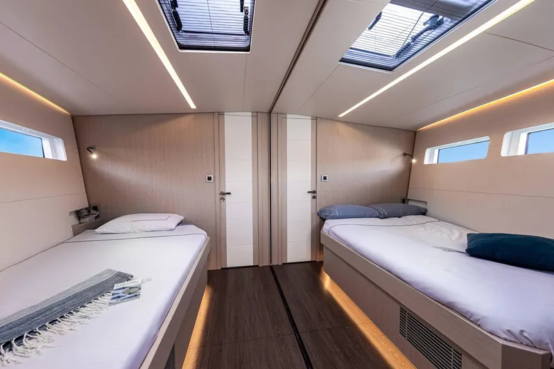  Yacht Photos Pics Luxurious 2022 Jeanneau 60 yacht cabin with twin beds and modern design.