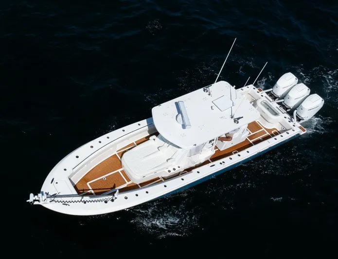  Yacht Photos Pics 2023 Invincible 36 Open boat with triple engines on the water.