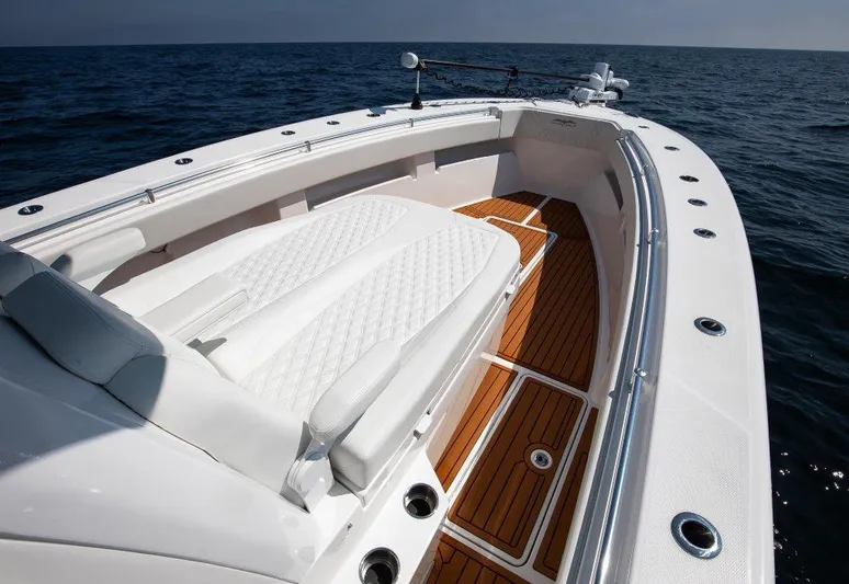  Yacht Photos Pics 2023 Invincible 36 Open boat with white seating and teak deck on open water.