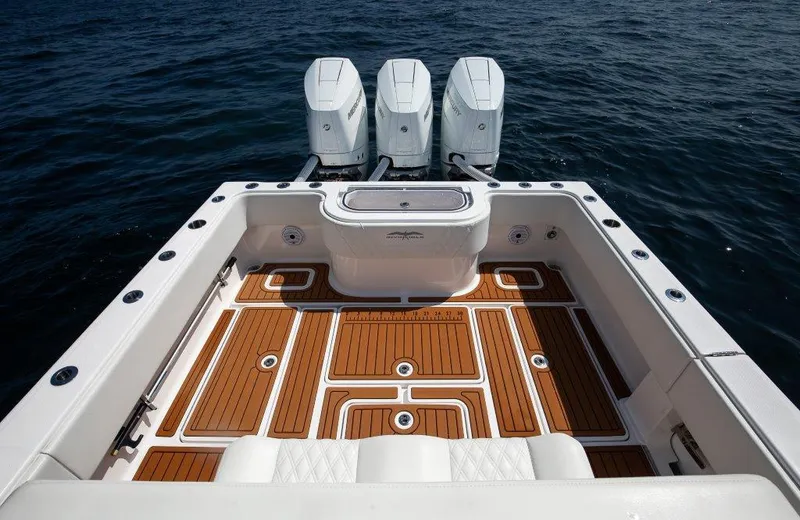  Yacht Photos Pics 2023 Invincible 36 Open boat with triple engines and teak deck on open water.