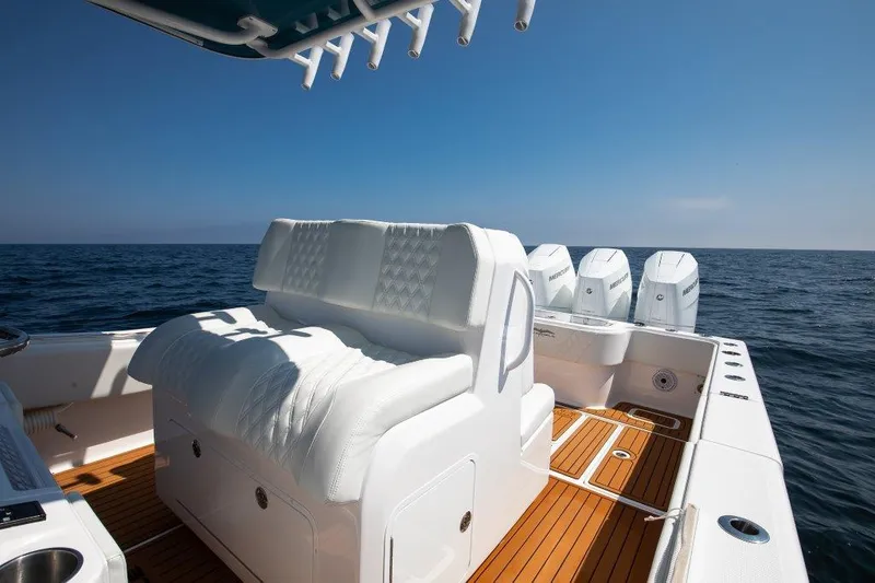  Yacht Photos Pics 2023 Invincible 36 Open boat with white seating and multiple engines on open water.