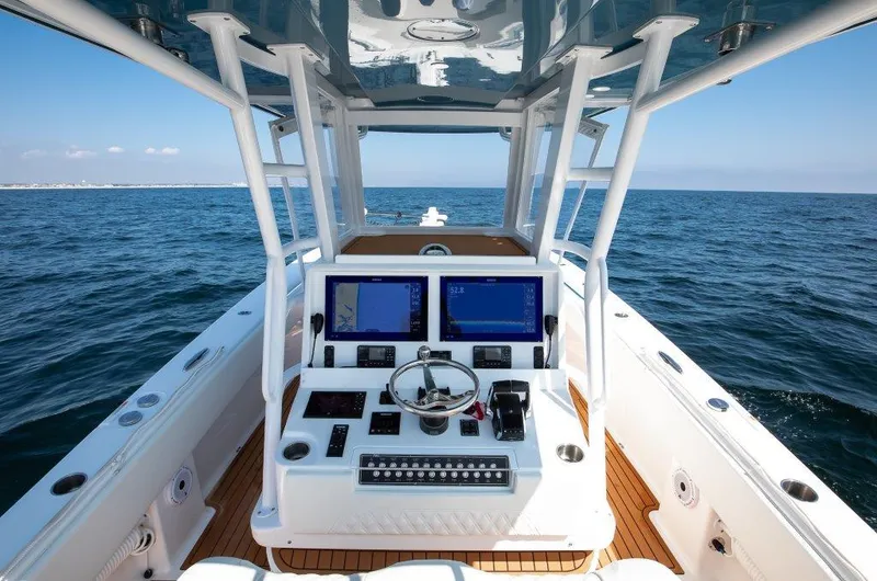 Yacht Photos Pics 2023 Invincible 36 Open boat dashboard with ocean view and navigation screens.