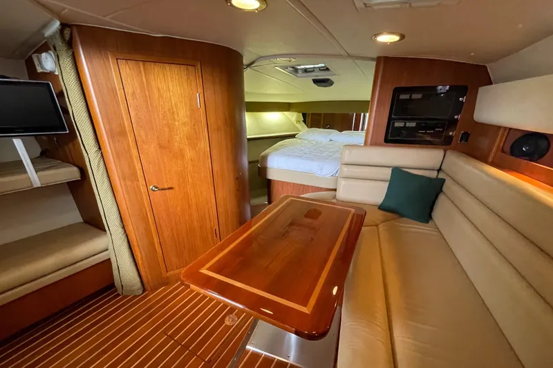  Yacht Photos Pics Luxurious interior of a 2002 Pursuit 3800 Express yacht with wood finishes and cozy seating.