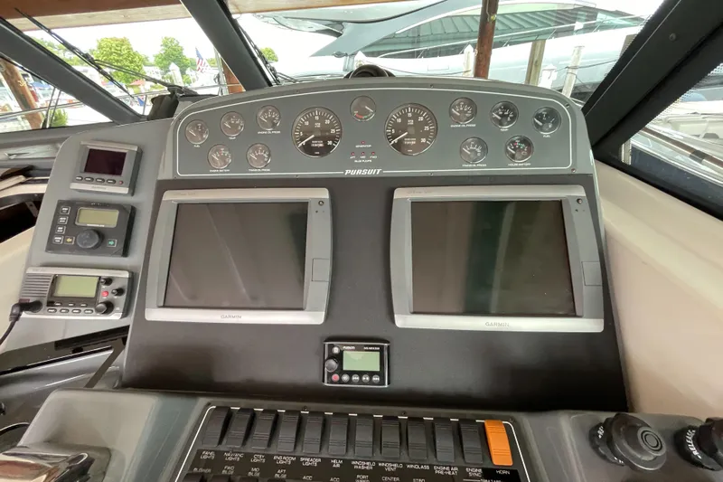  Yacht Photos Pics Control panel of a 2002 Pursuit 3800 Express boat with dual screens and gauges.