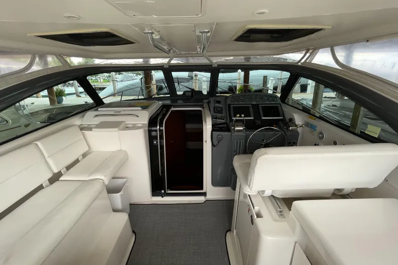  Yacht Photos Pics Interior of 2002 Pursuit 3800 Express yacht with white seating and modern helm.