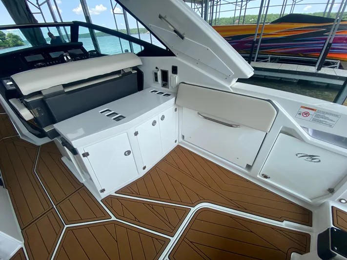  Yacht Photos Pics 2022 Monterey 385 Super Sport boat interior with sleek white cabinetry and wood-patterned flooring.