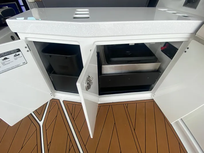  Yacht Photos Pics Open storage compartments on a 2022 Monterey 385 Super Sport boat with teak flooring.