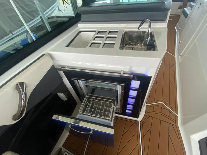  Yacht Photos Pics 2022 Monterey 385 Super Sport boat interior with sink, stove, and open drawer.