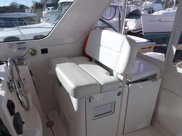  Yacht Photos Pics 2007 Tiara Yachts 3600 Sovran helm seat with white upholstery and steering wheel.