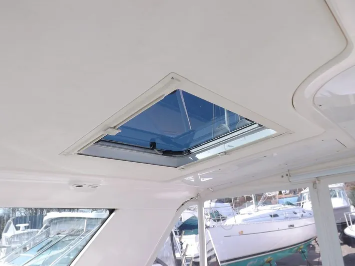  Yacht Photos Pics 2007 Tiara Yachts 3600 Sovran interior with open sunroof, docked boats visible outside.