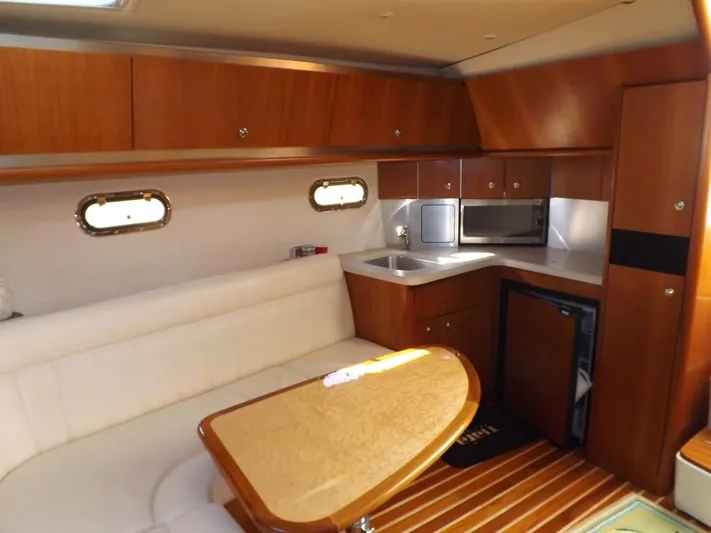  Yacht Photos Pics 2007 Tiara Yachts 3600 Sovran interior with kitchenette and seating area.