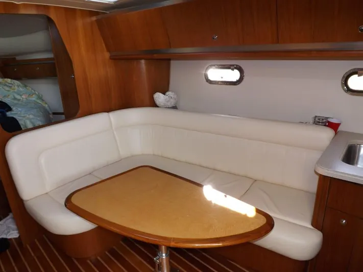  Yacht Photos Pics 2007 Tiara Yachts 3600 Sovran interior with white seating and wooden table.
