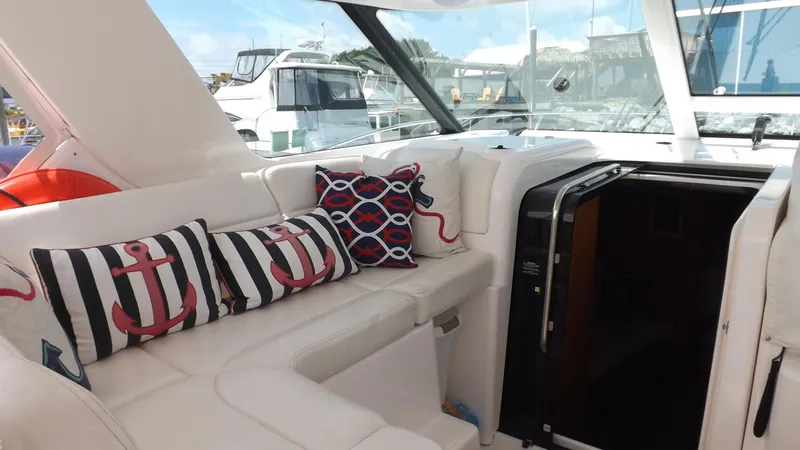  Yacht Photos Pics 2007 Tiara Yachts 3600 Sovran interior with nautical-themed cushions and sleek white seating.