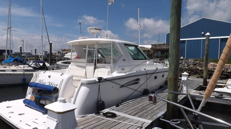  Yacht Photos Pics 2007 Tiara Yachts 3600 Sovran docked at marina, clear sky, blue building in background.