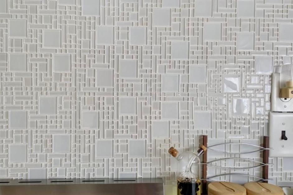 White geometric tile backsplash with kitchen items, featuring a 1986 Stardust Cruisers 52 model.