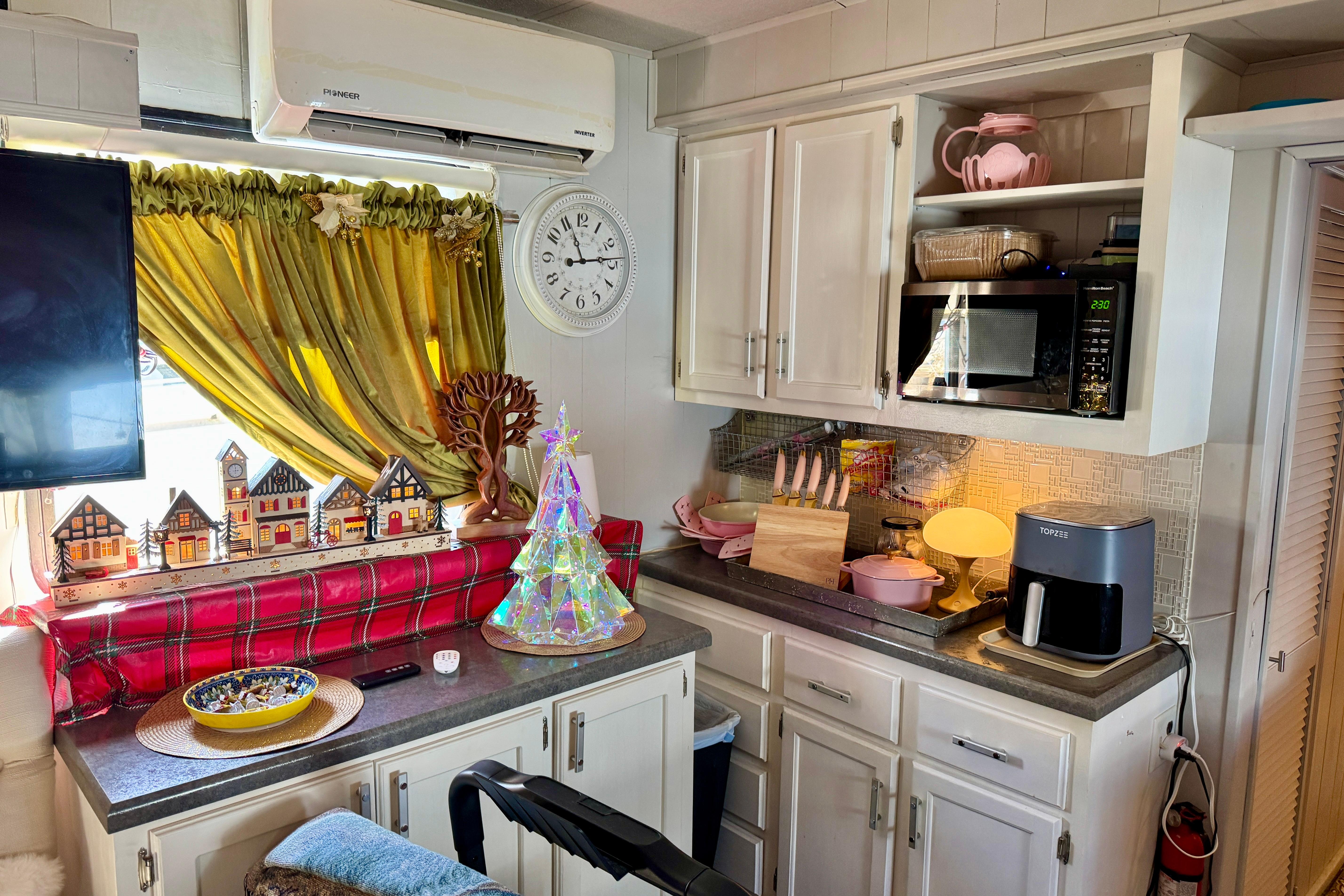 Cozy kitchen in 1986 Stardust Cruisers 52 houseboat with festive decor and modern appliances.