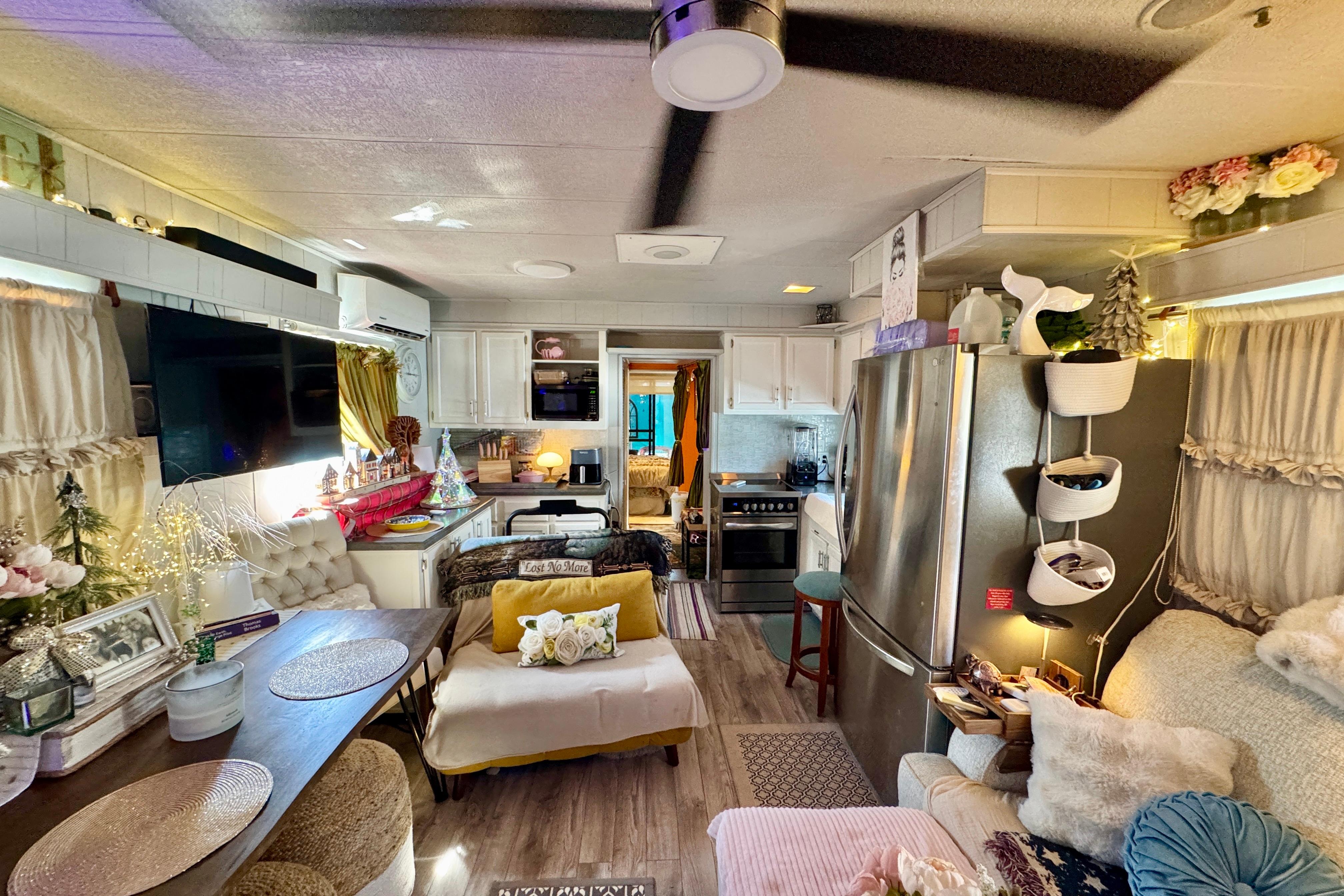 Interior of a cozy 1986 Stardust Cruisers 52 houseboat with modern decor and kitchen.